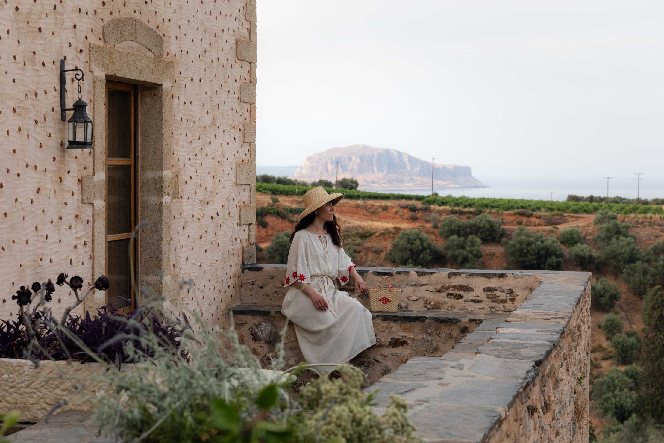 Woman standing in the balcony of Kinsterna Hotel, Monemvasia