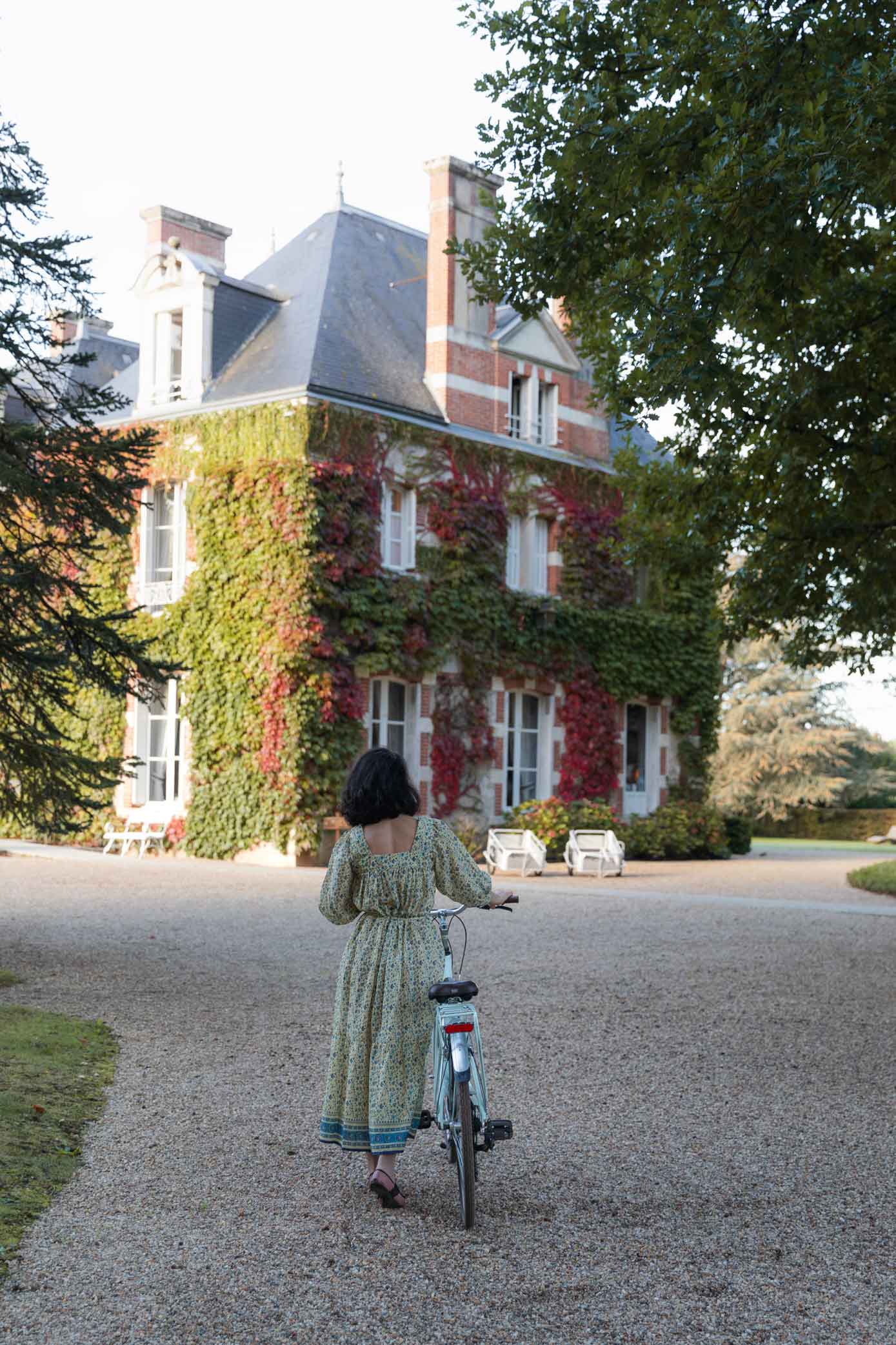 Woman with a bike at Domaine Les Hauts De Loire, Loire Valley